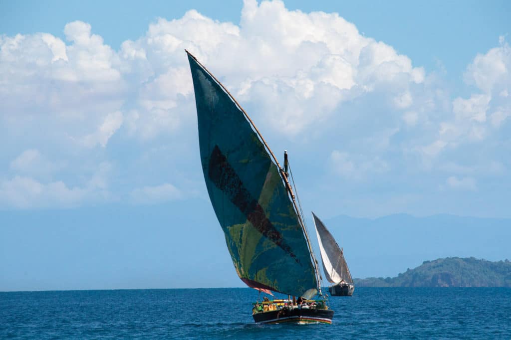 A pair of traditional dhows reach along on a sea breeze.