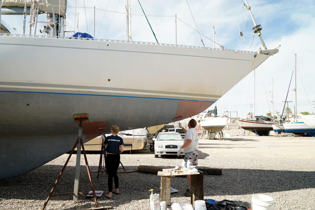 Painting the bottom of a boat.