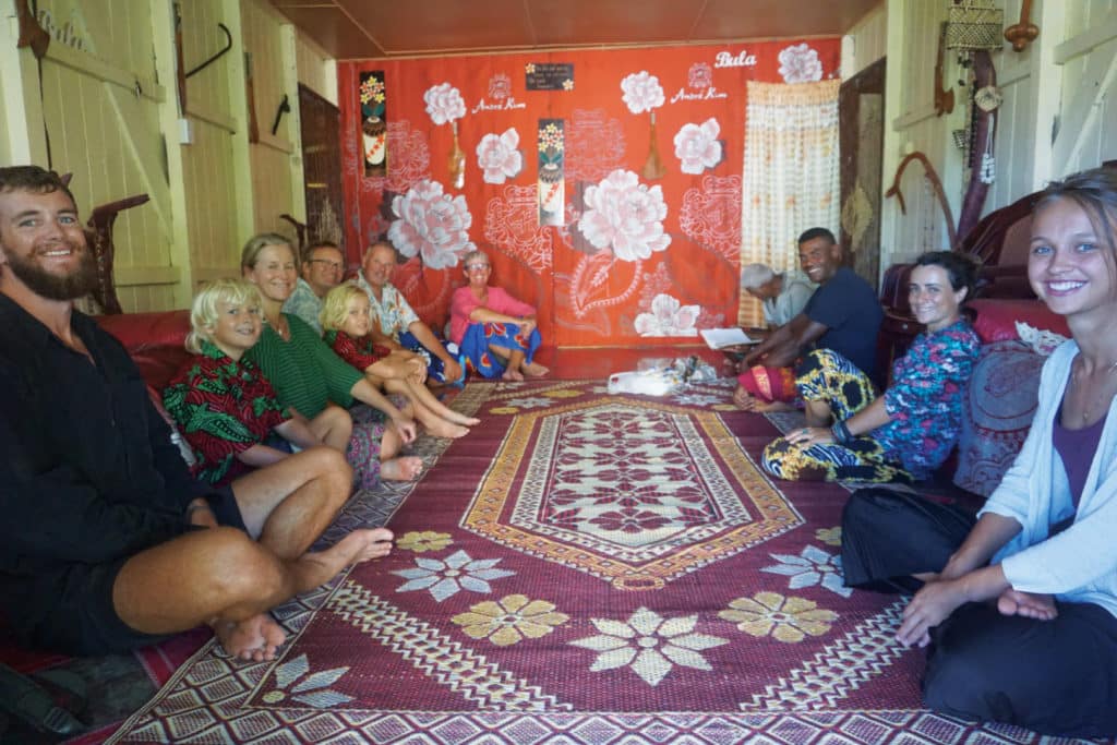 Sailors visiting the home of a Fiji local.