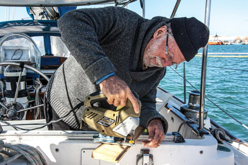 Cutting a wood board on a sailboat.