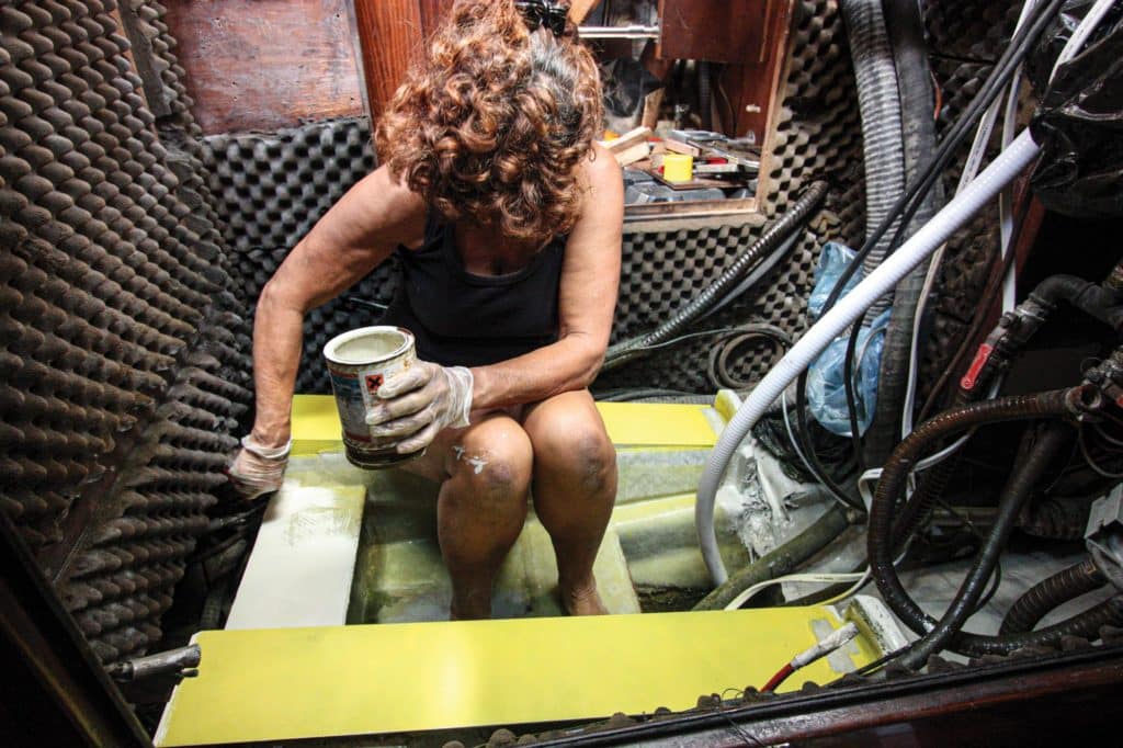 Painting a sailboat engine bed.