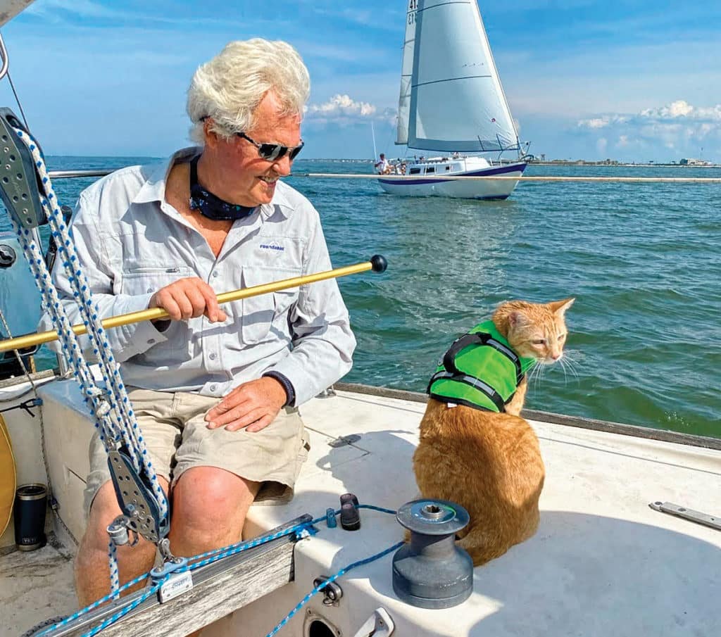 A sailor and his cat on a boat.