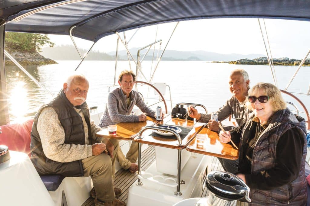 A family eating dinner on a sailboat.