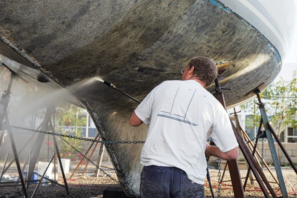 Stripping paint off the bottom of a boat.