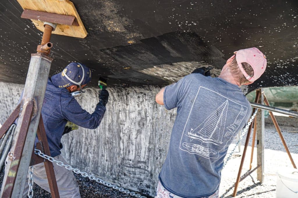 Stripping paint off the bottom of a boat.