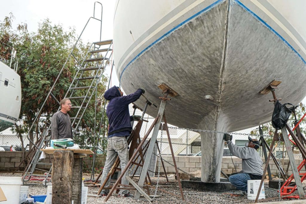 Stripping paint off the bottom of a boat.