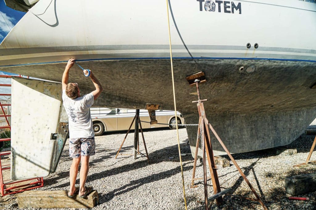 Stripping paint off the bottom of a boat.