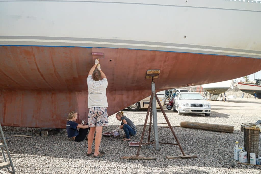Painting the bottom of a boat.