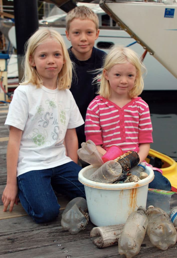 kids cleaning trash from local waters
