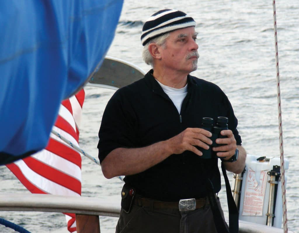 Frank Blair holding a pair of binoculars