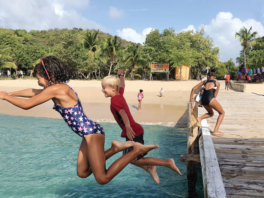 kids jumping off a dock