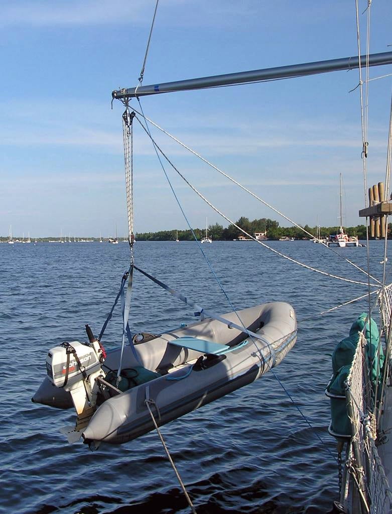 A dinghy hoisted out of the water