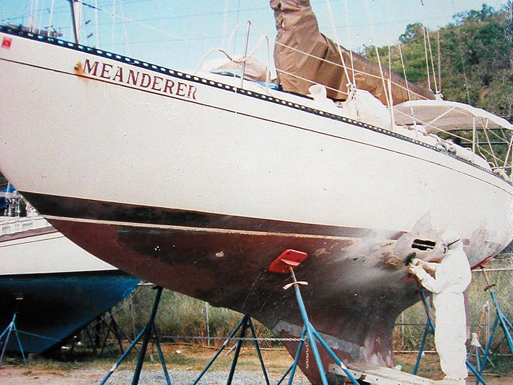 Grinding the fiberglass hull