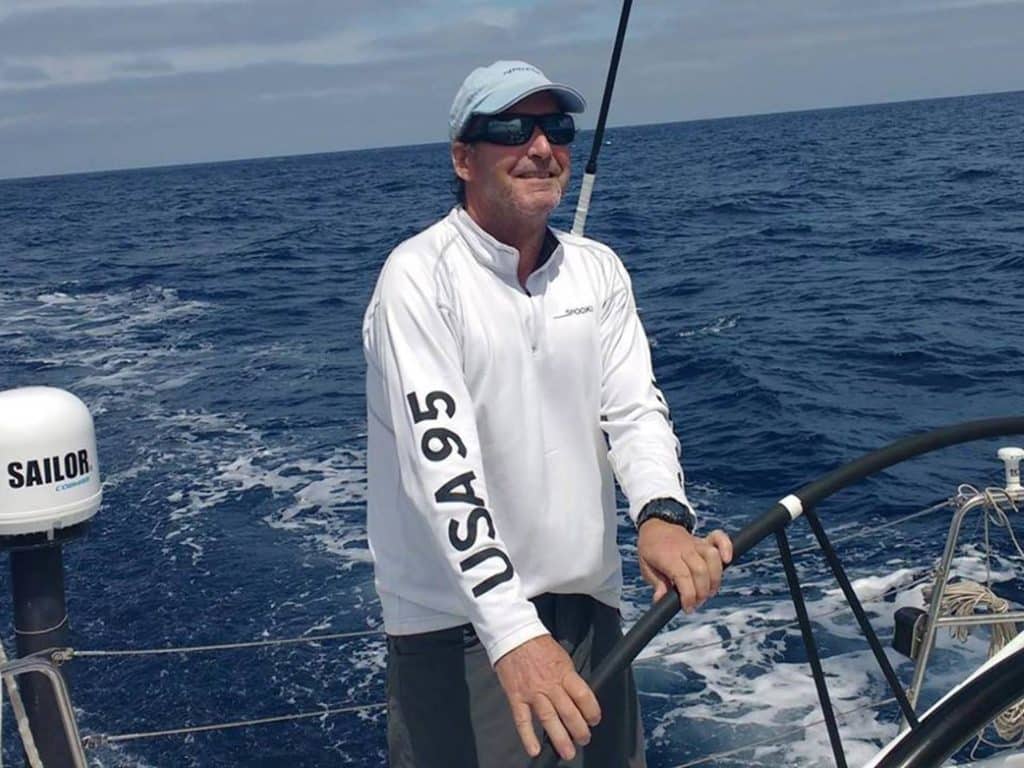Peter Isler steering a boat