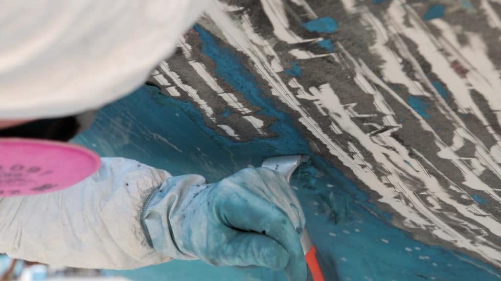 Scraping paint off the bottom of a boat