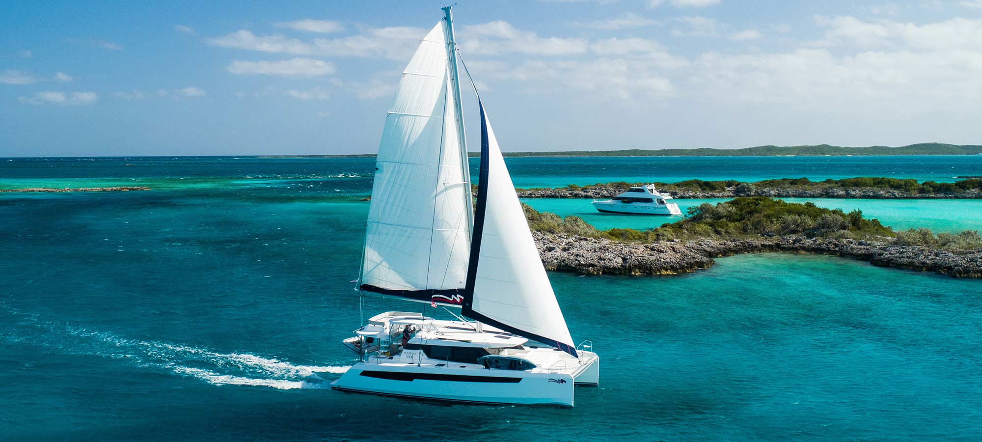 The Moorings sailboat on the water near a reef.