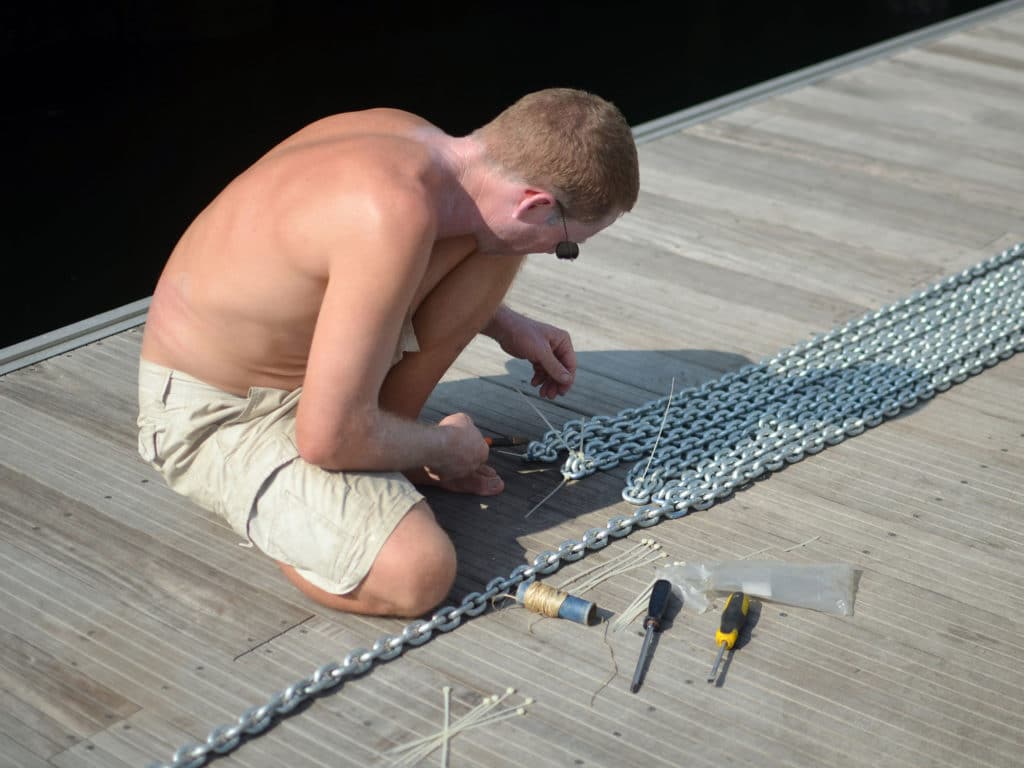 Applying zip ties to the anchor chain