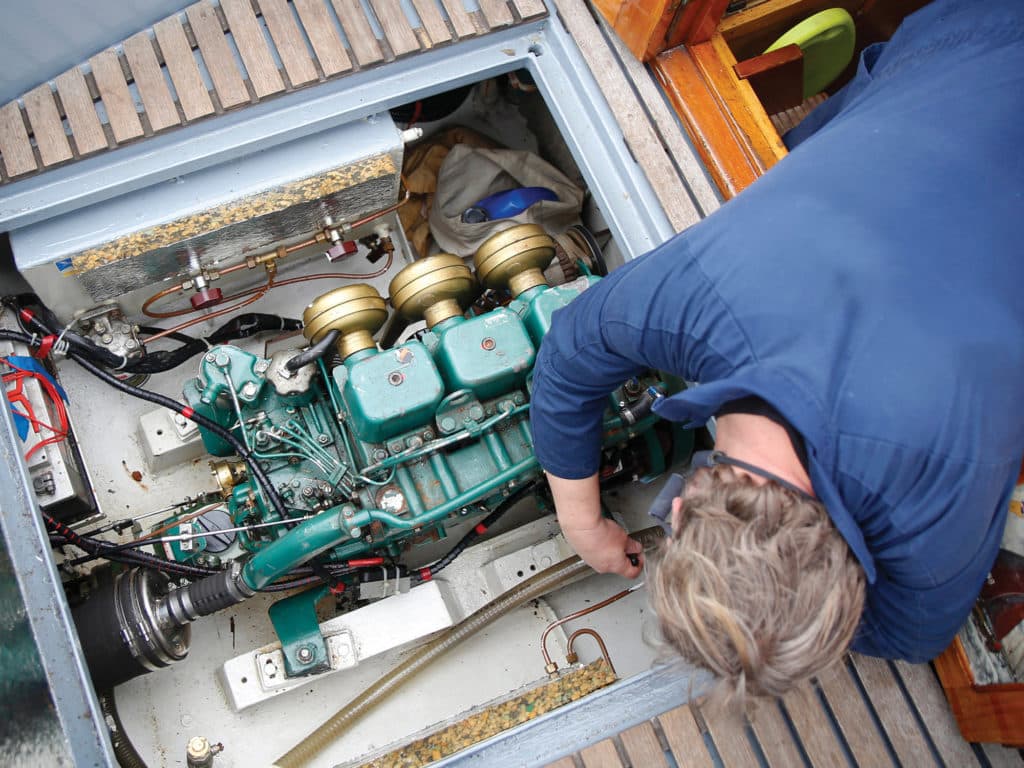 A service engineer fixing the engine of a vessel