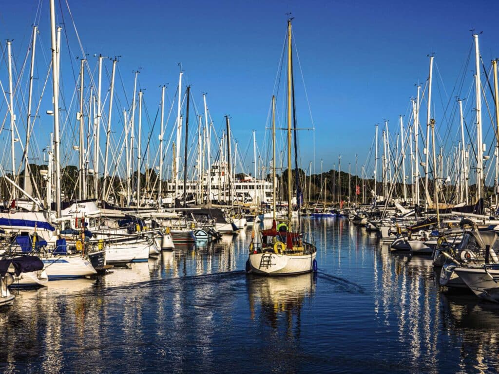 sailboat leaving a dock