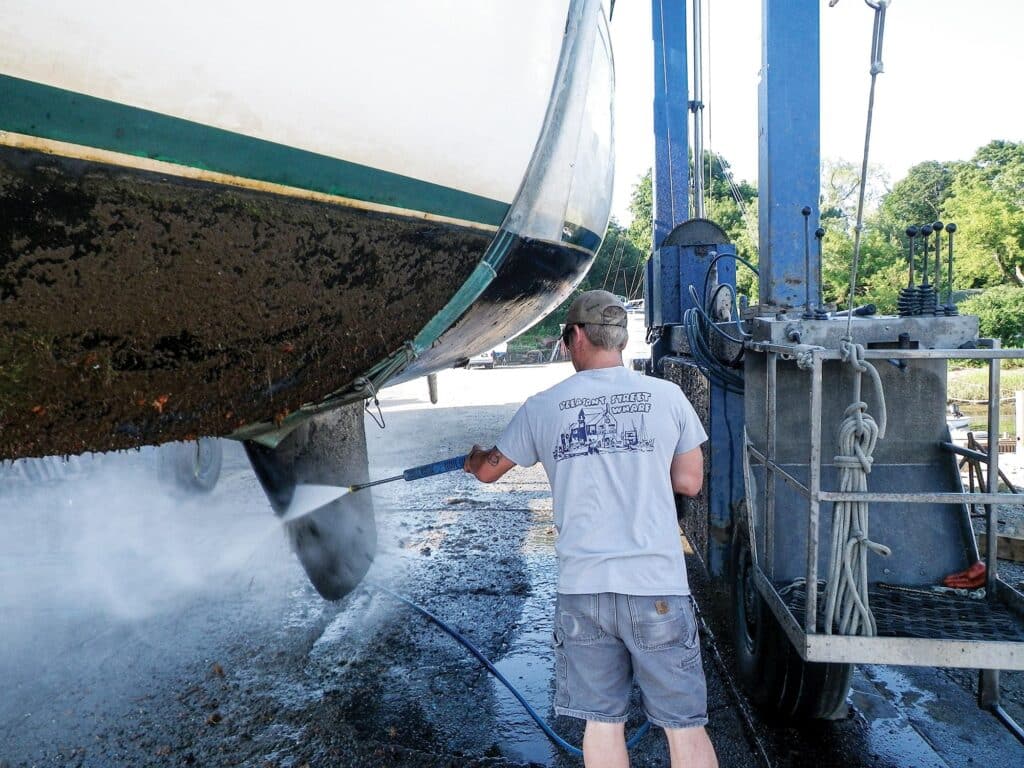 Boat bottom and topsides getting power-washed.