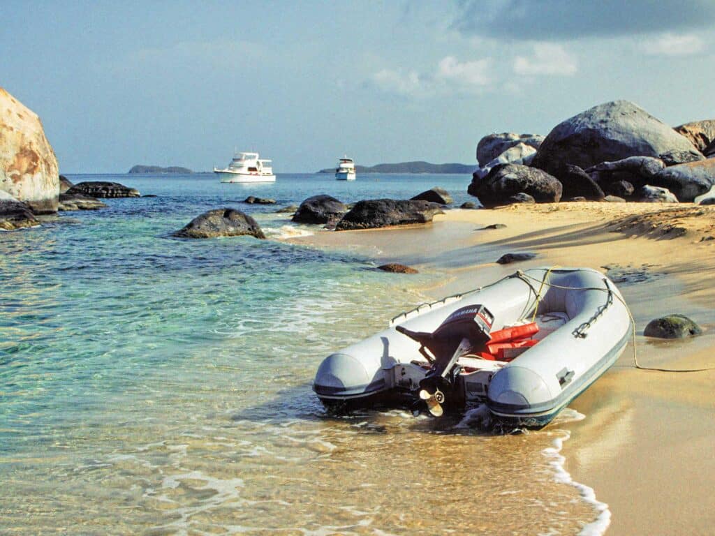 Inflatable boat with motor on shore