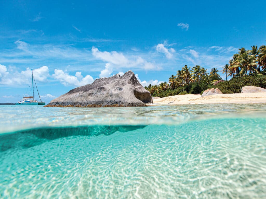 Beautiful tropical beach with white sand, turquoise ocean water and blue sky at Virgin Gorda, British Virgin Islands in Caribbean