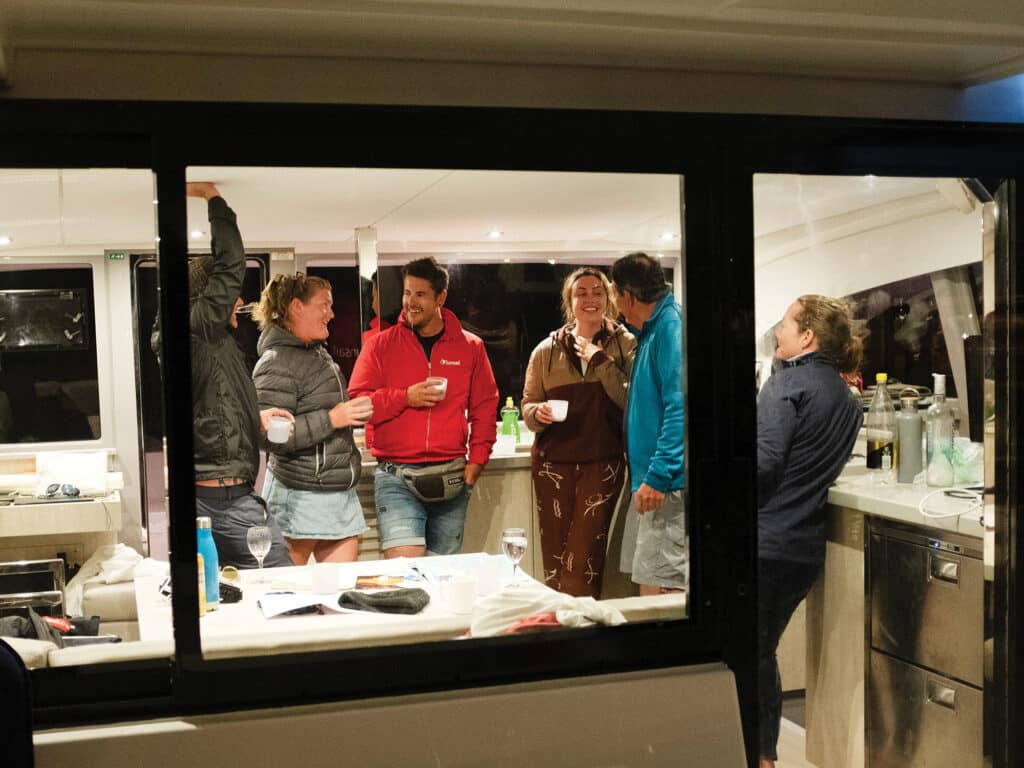 People hanging out at night on a catamaran