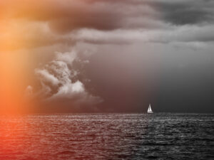 Boat Sailing in Center of Storm Formation. Dramatic Background.