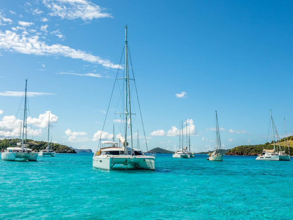 Turquoise colored sea with ancored yachts and catamarans, Tobago Cays tropical islands, Saint Vincent and the Grenadines, Caribbean sea