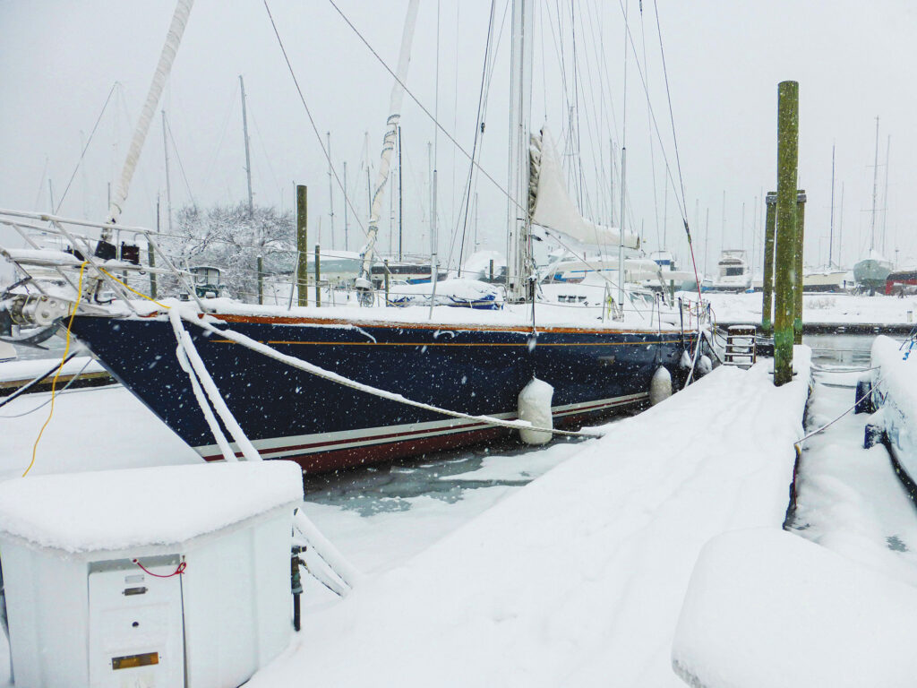 A sailboat at dock in the winter