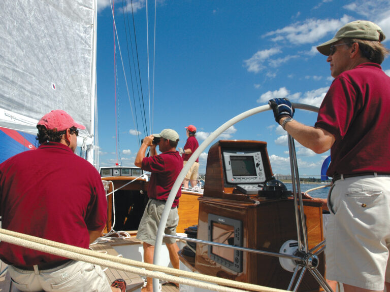 Man steering a sailboat