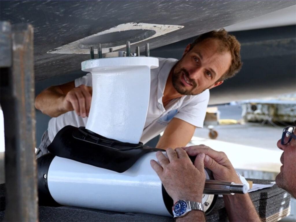 People placing a propeller on a boat