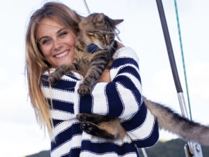 Woman holding a cat on a sailboat