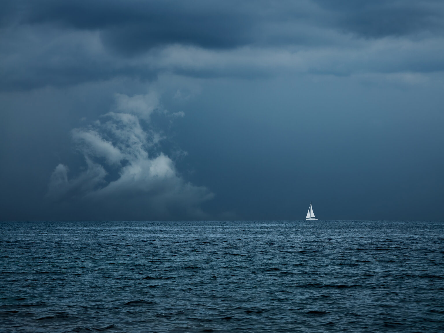 Boat Sailing in Center of Storm Formation