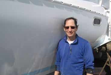 John Lombardi 368 John Lombardi pauses between trimaran flights to reflect in his handiwork.