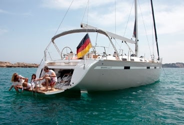 The fold-down transom door on the Jeanneau 57 functions as a spacious swim platform and offers access to dinghy storage.