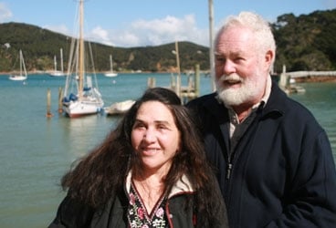 Lin and Larry Pardey, at home on New Zealand's Kawau Island, pose with their well-traveled 29-footer, Taleisin.