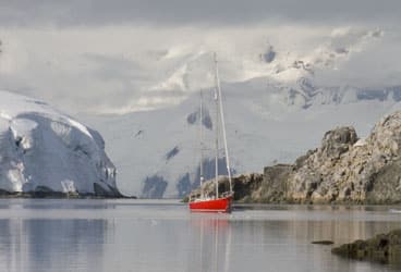 Secured with lines to shore, Northern Light lies at anchor at Melchior Island, her crew's jumping-off point for the return to South America after their Antarctic Peninsula visit.