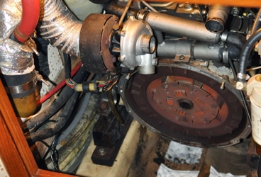 Tranny out. The job was surprisingly simple, just bolts around the bell housing. The challenge was separating the coupling.