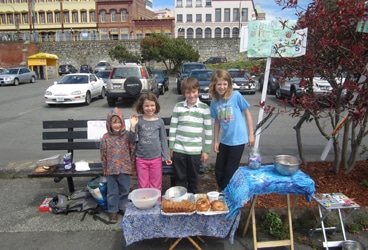 Del Viento- bake sale Late in their hours-long sale. The cookies are nearly gone, the second loaf of banana bread is out, the Riki Tiki Tavi kids have left, and lots of rocks still for sale on the table to the right. Pictured are Jonah, Frances, Kai, and Eleanor.