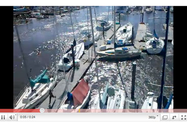 The charter fleet at Pacific Yachting and Sailing crashes into the docks in rolling waters.