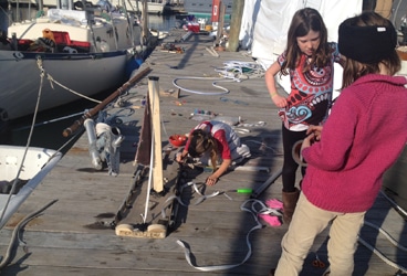 The girls discussing boat design. Never mind the mess on the dock—the grown-ups were probably to blame as we were all preparing our boats for the coming winter.