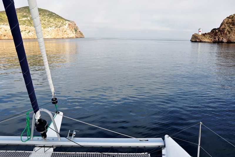 The red and white light at Punta de Sa Creveta marks the harbor entrance.