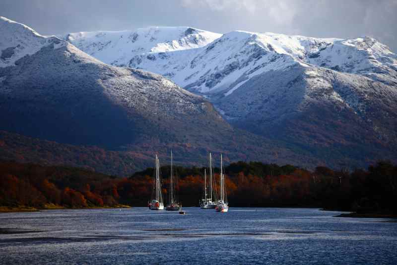 Cape Horn/Antarctic Expedition boats at anchor in the protected waters of Seno Lauta Harbour. In the background is the dramatic back-drop of of Argentina's Martial Mountain Range located across the Beagle Channel from Isla Navarino. Puerto Williams, Isla Navarino - Chile. Early Winter / 2014