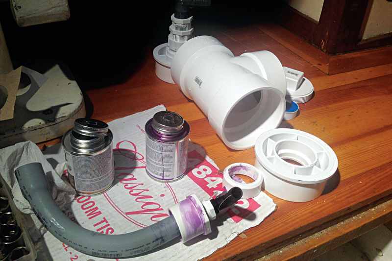 A large PVC tee fitting and other common plumbing parts were used to fashion a robust gray-water sump.