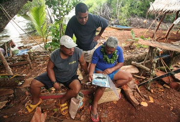 Micronesia A Micronesian chief and his cabinet members check out a copy of Cruising World with Wild Card on the cover.