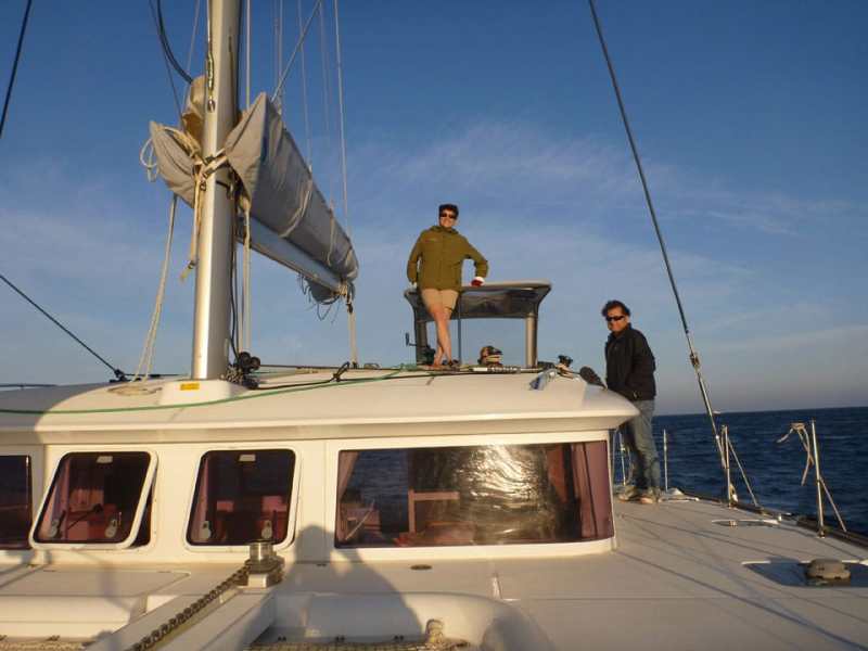 Charter editor Elaine Lembo enjoys the sunset on the downwind run back to the base.