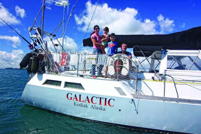 The Litzow family lives aboard their boat, Galactic. Netting strung around the cockpit helps make a secure play area when sailing offshore.