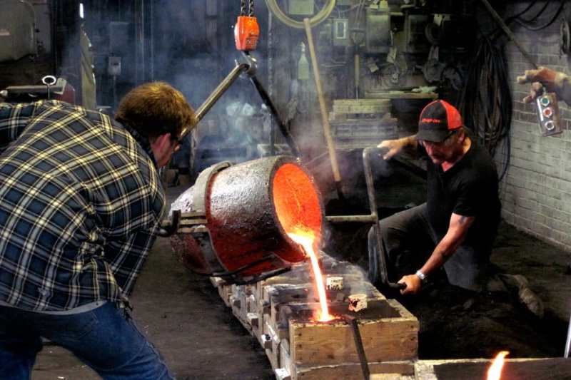 Lunenburg Foundry Modern masters of molten metal, Lunenburg Foundry employees—foreman John Jennings (right) and his son, Cody (left)—pour glowing bronze that will soon cool to assume new shapes as parts of marine stuffing boxes.