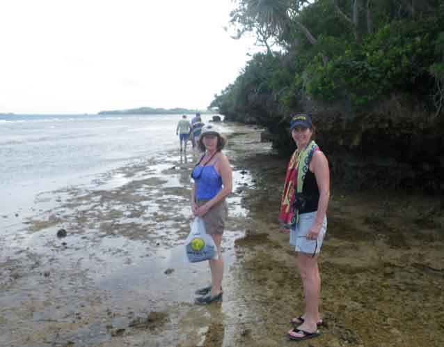 Walk on the beach A receding tide uncovers a wide shelf of rock and gives us good footing as we walk the beach. Peggy (left) and Sue humor my need to snap a photo.